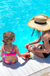 © yanadjan - Children eat watermelon near the pool. selective focus.
