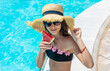 © yanadjan - girl eating watermelon near the pool. selective focus.