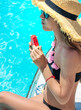 © yanadjan - girl eating watermelon near the pool. selective focus.