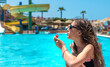 © yanadjan - girl eating watermelon near the pool. selective focus.