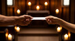 © MDABDUL - Communion wafer exchange between two hands in a dimly lit church