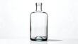 © Nusaibah - A tall, clear glass bottle with a rounded body and slender neck stands against a stark white backdrop. The bottle is empty