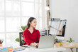 © Wicitr - Asian Businesswoman Using laptop computer and working at office with calculator document on desk, doing planning analyzing the financial report, business plan investment, finance analysis concept.