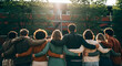 © Rabea - Diverse group of young adults standing together with arms around each other outdoors