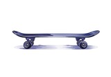 A skateboard lies on the ground with wheels facing outward