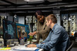 © DC Studio - Diverse team of engineers using artificial intelligence to design a floor plan, working together with neural networks and computer aided apartment layout on architectural software.