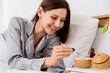 © Pixel-Shot - Young woman dropping essential oil into air humidifier in bedroom