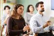 © JackF - Woman listens attentively to teacher and takes notes in notebook during a professional development course