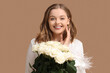 © Pixel-Shot - Beautiful young woman with bouquet of white roses on beige background