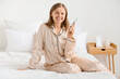 © Pixel-Shot - Young woman with syringe of IVF hormones sitting in bedroom