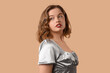 © Pixel-Shot - Beautiful young woman with bob hairstyle on brown background