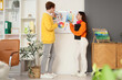 © Pixel-Shot - Couple of graphic designers working with color palettes on whiteboard in office