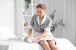 © Pixel-Shot - Young chambermaid with clean towels in room