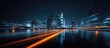 © rifky - Vibrant night cityscape with blurred light streaks over a reflective wet ground