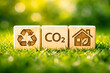 © IMRAN - Wooden blocks with eco-friendly symbols on grass