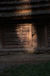 © phpetrunina14 - Sunlit rustic wooden cabin with thatched roof and old door Ukraine
