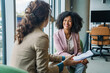 © Miljan Živković - Businesswomen discussing documents in modern office