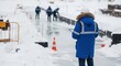 © MT - Male engineer in blue parka conducting arctic infrastructure site inspection in winter