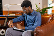 © zinkevych - Man writing on clipboard sitting in chair