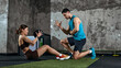 © master1305 - Fitness trainer guiding woman doing sit up exercise with medicine ball in gym. Concept of core training, personal coaching, strength development and healthy fitness routine