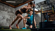 © master1305 - Woman pushing weighted sled while man supervising training session in gym. Concept of strength training promo, fitness ads campaign, athletic branding and performance coaching service marketing