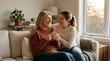 © kandoalchemist - Older mother and adult daughter laughing on sofa with coffee, Mother's Day