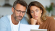 © sabyna75 - Concerned caucasian adults reviewing documents together at home