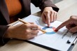 © onyengradar - Hands analyzing charts and graphs on documents, showing teamwork in a professional workspace.