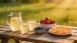 © PixelNexusArt - Labor day picnic with pitcher of lemonade two glasses and fresh fruit on wooden table in warm sunlight