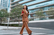 © Stock 4 You - Asian businesswoman using smartphone on city street, professional career woman checking online banking and finance apps, walking near business office buildings in urban downtown. Full body, copy space