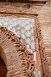 © Sunlight - Alhambra moorish architecture with intricate brickwork carvings and colorful arabesque ceramic tiles