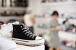 © JackF - Women's comfortable sneakers displayed on shelf in shoe store