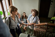 © Marko Geber - Smiling college students chatting on a university stairwell