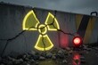 © starush - Glowing radiation symbol on cracked concrete barrier with red warning light