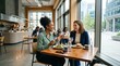 © Alvaro - Two Diverse Businesswomen Laughing and Enjoying a Healthy Lunch Meeting in a Modern City Restaurant