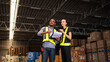 © kelvn - Warehouse manager talking and checking product in warehouse.