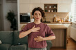 © La Famiglia - Woman practicing mindful breathing and meditation at home