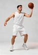 © UMAIR - Athletic young man in white uniform focuses intently while holding a basketball high above his head during a professional photoshoot session to showcase his skills and physical fitness level for a spo