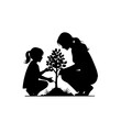 © rioyoungguns - Silhouette of mother and daughter planting a tree