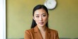 © Andrii Zastrozhnov - Young asian woman posing with neutral expression in office interior