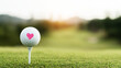 © Bonsales - Golf ball with a pink heart symbol on a tee, representing love for the game and special moments