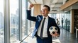 © Влада Яковенко - Successful businessman celebrates victory holding a soccer ball in modern office