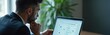 © Pete - Man in suit ponders choice on online survey. Laptop shows checkboxes on screen. Professional thinks hard, studies data. Person evaluates options. Future planning work.