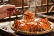 © zhang yongxin - Steaming crabs served in a bamboo basket, being lifted with chopsticks, showcasing fresh seafood cuisine.