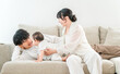 © buritora - A young family spending time with their baby on the living room sofa in their home.