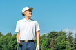 © buritora - A male golfer in golf attire amidst fresh greenery (golf course, academy, membership).