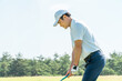 © buritora - A male golfer playing golf on a golf course (tee shot, golf competition)