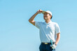 © buritora - A male golfer playing golf on a golf course (smiling)