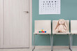© Pixel-Shot - Toy bunny with cubes on chairs in pediatrician's hall