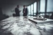 © AhmadFirdaus - Two professionals in a modern office discussing business over a marble table with a notebook and pen